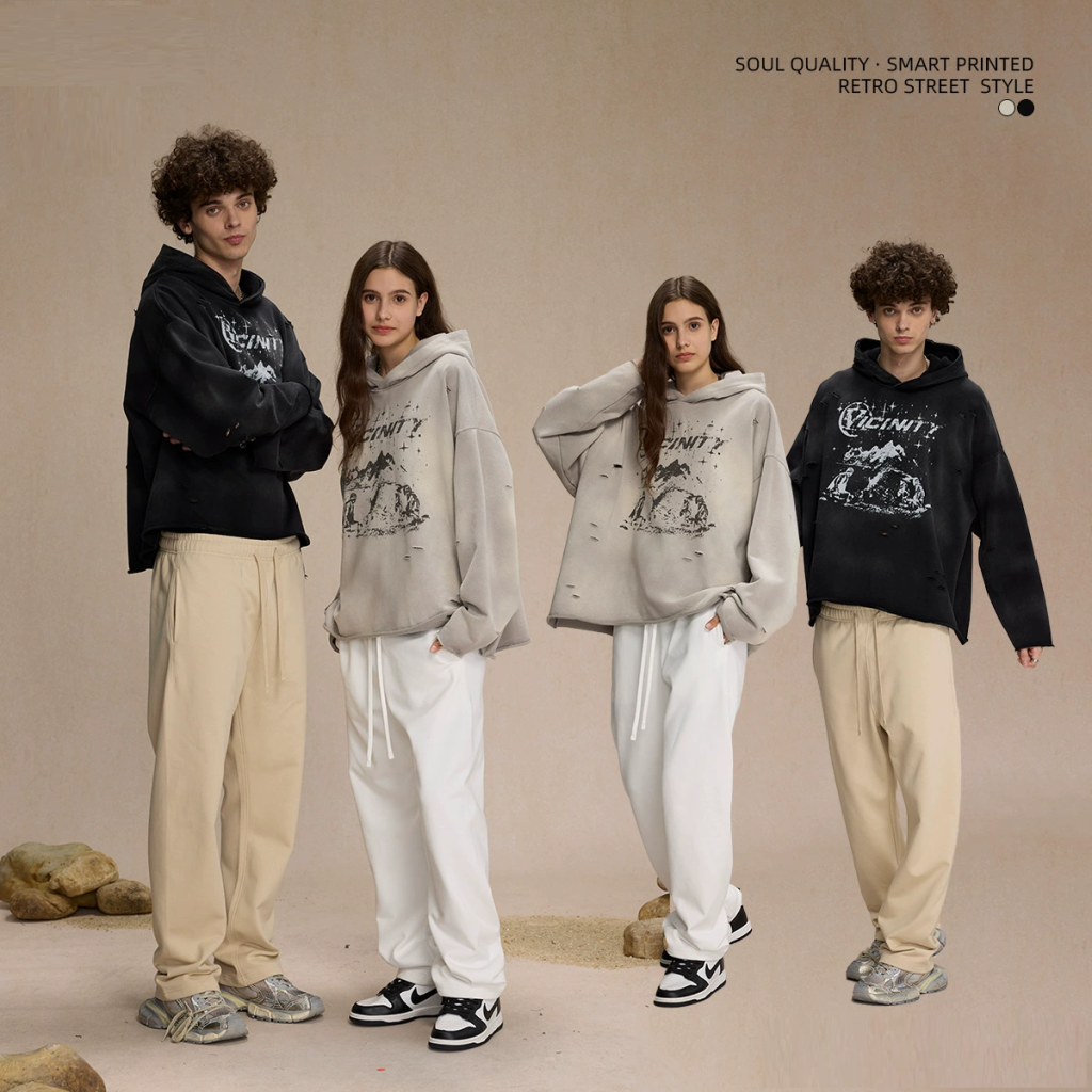 Irregular holes with distressed spray print hoodie supplier